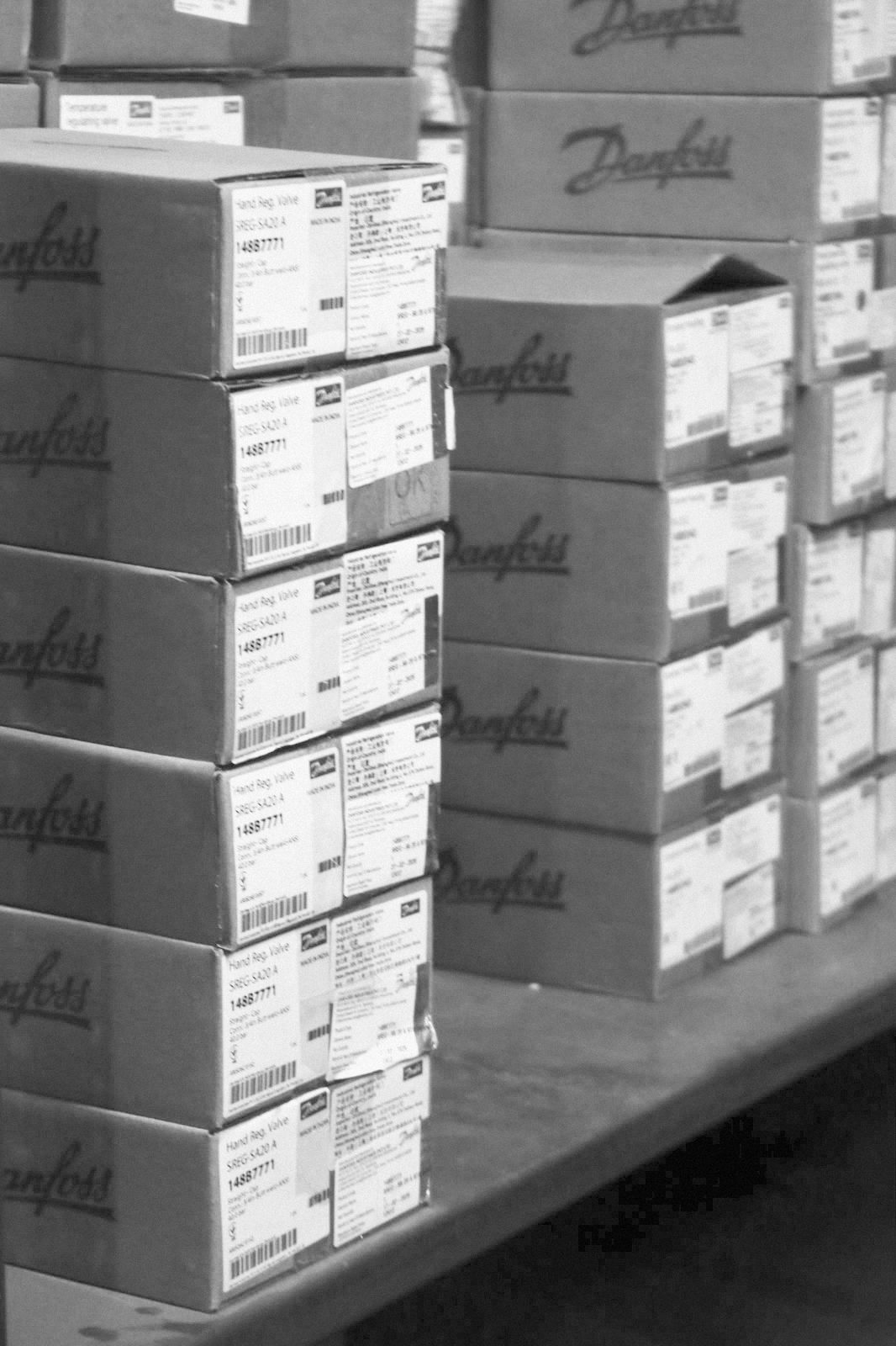 Hand regulating valve cartons on the shelf at the PMR stores